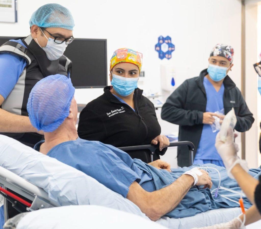 Medical team attending patient on hospital bed